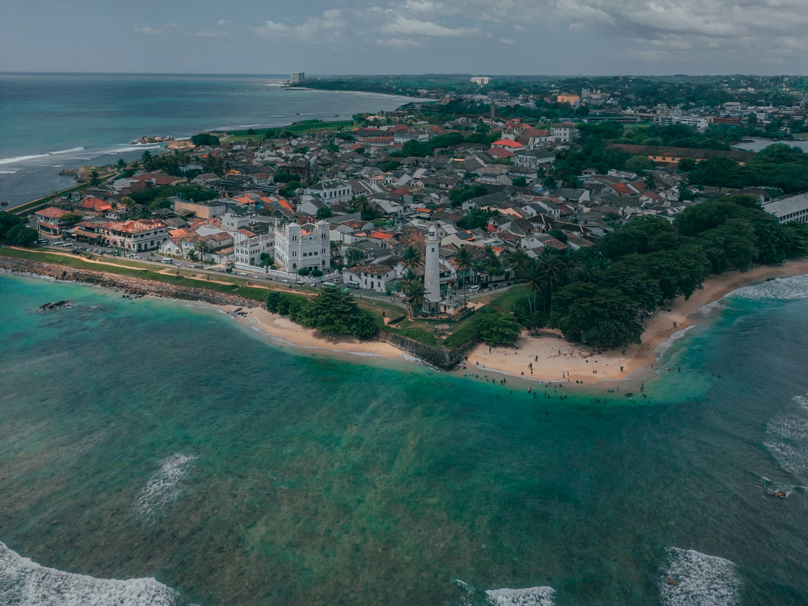 Aerial view of Galle Dutch Fort with its white lighthouse, beach and turquoise sea